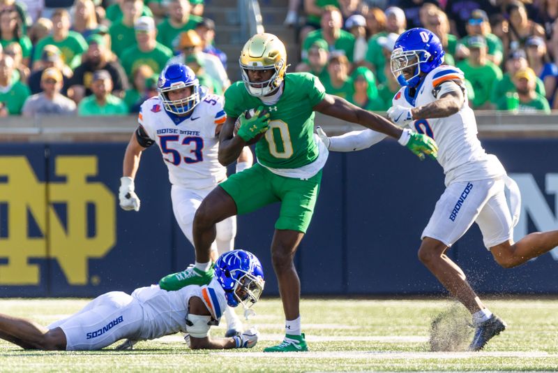 Oct 4, 2025; South Bend, Indiana, USA; Notre Dame Fighting Irish wide receiver Malachi Fields (0) fights for extra yards against the Boise State Broncos during the first half at Notre Dame Stadium. Mandatory Credit: Michael Caterina-Imagn Images