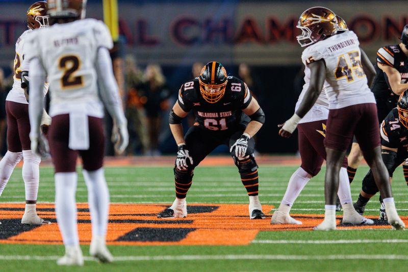 Nov 2, 2024; Stillwater, Oklahoma, USA;  Oklahoma State Cowboys offensive lineman Jake Springfield (61) ready for the play against the Arizona State Sun Devils during the fourth quarter at Boone Pickens Stadium. Mandatory Credit: William Purnell-Imagn Images