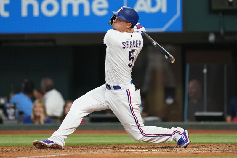 Sep 20, 2023; Arlington, Texas, USA; Texas Rangers shortstop Corey Seager (5) follows through on an RBI double against the Boston Red Sox during the fifth inning at Globe Life Field. Mandatory Credit: Jim Cowsert-USA TODAY Sports