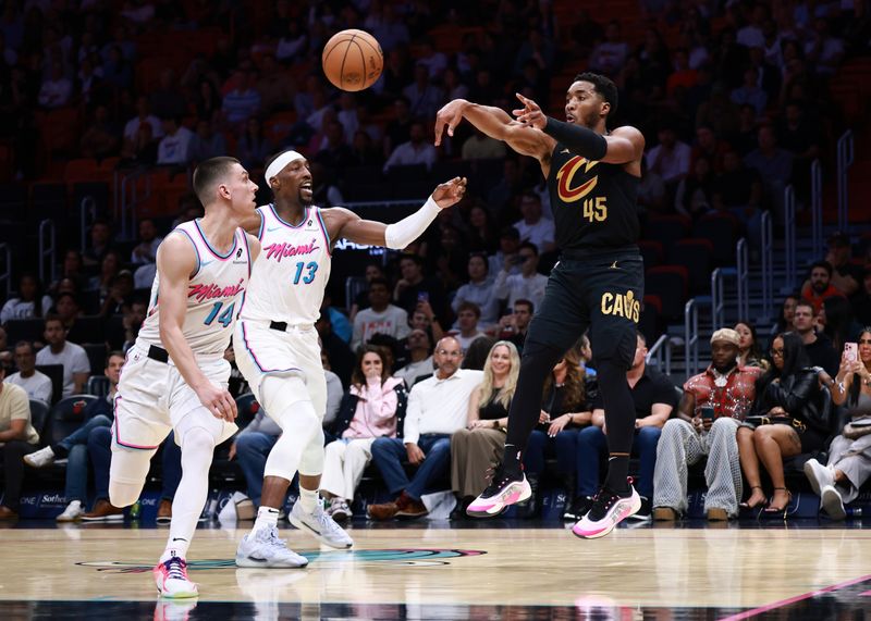 MIAMI, FLORIDA - JANUARY 29: Donovan Mitchell #45 of the Cleveland Cavaliers passes the ball ahead of Bam Adebayo #13 of the Miami Heat during the second half at Kaseya Center on January 29, 2025 in Miami, Florida.  NOTE TO USER: User expressly acknowledges and agrees that, by downloading and or using this Photograph, user is consenting to the terms and conditions of the Getty Images License Agreement. (Photo by Carmen Mandato/Getty Images)