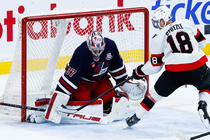 Dec 15, 2025; Winnipeg, Manitoba, CAN;  Winnipeg Jets goalie Connor Hellebuyck (37) stops a shot by Ottawa Senators Ottawa Senators forward Tim Stutzle (18) during the overtime period at Canada Life Centre. Mandatory Credit: Terrence Lee-Imagn Images
