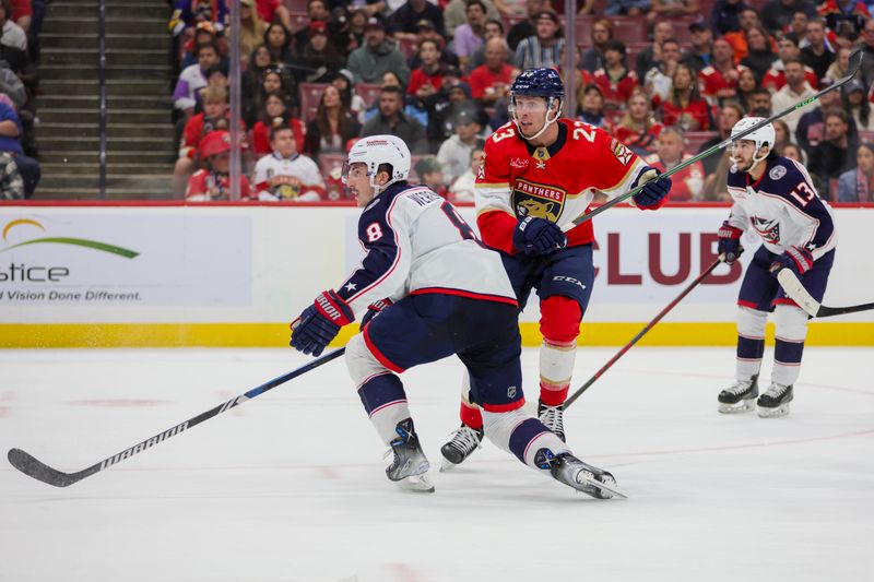 Nov 6, 2023; Sunrise, Florida, USA; Florida Panthers center Carter Verhaeghe (23) and Columbus Blue Jackets defenseman Zach Werenski (8) look on during the second period at Amerant Bank Arena. Mandatory Credit: Sam Navarro-USA TODAY Sports