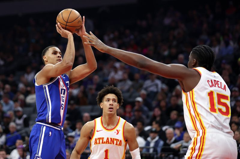 SACRAMENTO, CALIFORNIA - JANUARY 22: Keegan Murray #13 of the Sacramento Kings shoots over Clint Capela #15 of the Atlanta Hawks in the first half at Golden 1 Center on January 22, 2024 in Sacramento, California. NOTE TO USER: User expressly acknowledges and agrees that, by downloading and or using this photograph, User is consenting to the terms and conditions of the Getty Images License Agreement.  (Photo by Ezra Shaw/Getty Images)