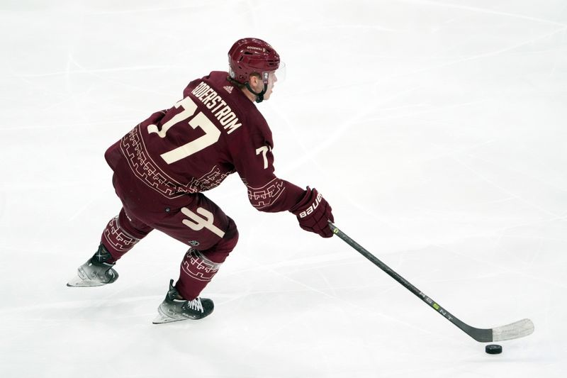 Mar 3, 2023; Tempe, Arizona, USA; Arizona Coyotes defenseman Victor Soderstrom (77) skates the puck against the Carolina Hurricanes during the third period at Mullett Arena. Mandatory Credit: Joe Camporeale-USA TODAY Sports