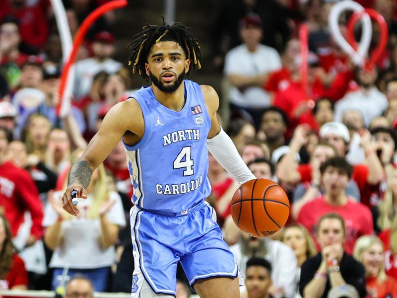 Feb 19, 2023; Raleigh, North Carolina, USA;  North Carolina Tar Heels guard R.J. Davis (4) dribbles the ball during the second half of the game against North Carolina State Wolfpack at PNC Arena. Mandatory Credit: Jaylynn Nash-USA TODAY Sports