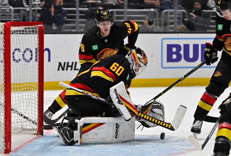 Apr 10, 2023; Los Angeles, California, USA;  Vancouver Canucks goaltender Collin Delia (60) makes a save in the second period against the Los Angeles Kings at Crypto.com Arena. Mandatory Credit: Jayne Kamin-Oncea-USA TODAY Sports