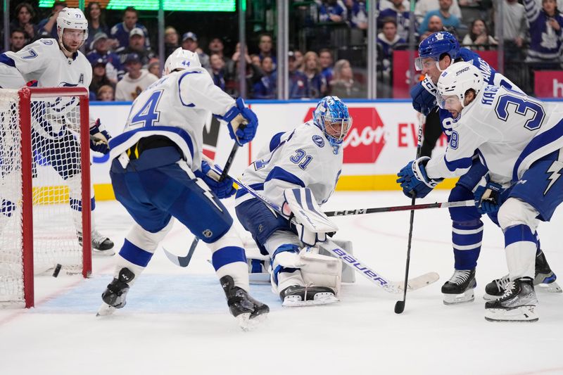 Nov 6, 2023; Toronto, Ontario, CAN; A shot by Toronto Maple Leafs forward John Tavares (91) goes wide of the net as Tampa Bay Lightning goaltender Jonas Johansson (31), defenseman Calvin de Haan (44), and forward Brandon Hagel (38) defend during the third period at Scotiabank Arena. Mandatory Credit: John E. Sokolowski-USA TODAY Sports