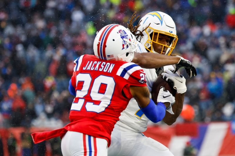 Los Angeles Chargers wide receiver Quentin Johnston (1) makes a catch while defended by New England Patriots cornerback J.C. Jackson (29) during the first half of an NFL football game on Sunday, Dec. 3, 2023, in Foxborough, Mass. (AP Photo/Greg M. Cooper)