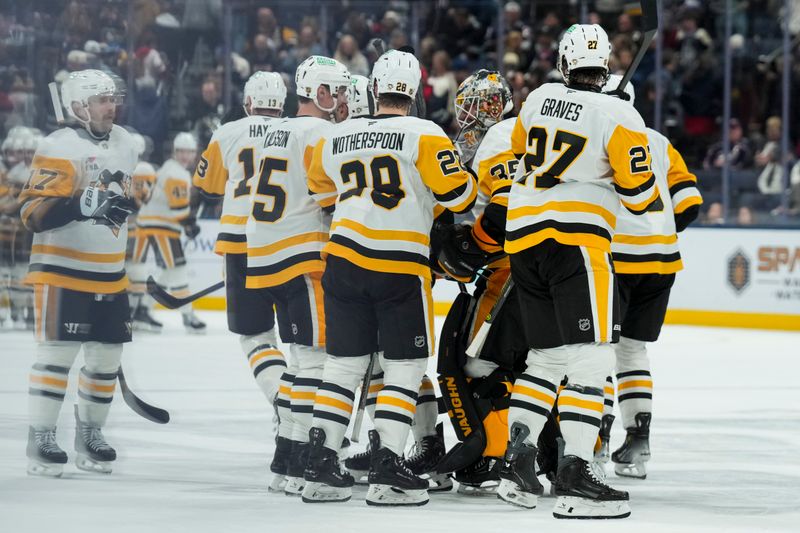 Nov 28, 2025; Columbus, Ohio, USA;  Pittsburgh Penguins goaltender Tristan Jarry (35) celebrates with teammates after his team’s win against the Columbus Blue Jackets in the overtime period at Nationwide Arena. Mandatory Credit: Aaron Doster-Imagn Images