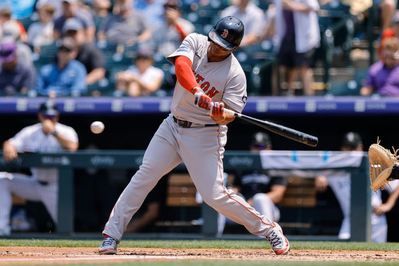Jul 24, 2024; Denver, Colorado, USA; Boston Red Sox designated hitter Rafael Devers (11) hits a double in the second inning against the Colorado Rockies at Coors Field. Mandatory Credit: Isaiah J. Downing-USA TODAY Sports