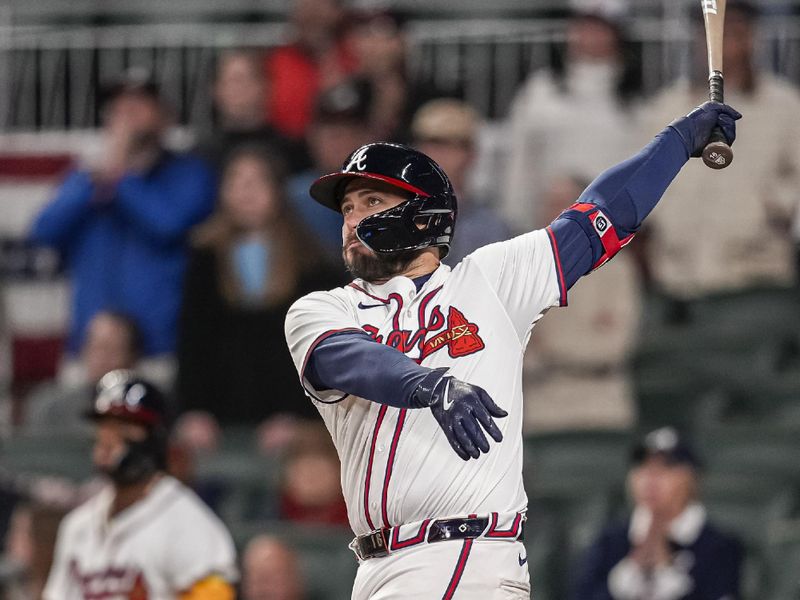 Apr 5, 2024; Cumberland, Georgia, USA; Atlanta Braves catcher Travis d'Arnaud (16) drives in the game winning run with a hit against the Arizona Diamondbacks during the tenth inning at Truist Park. Mandatory Credit: Dale Zanine-USA TODAY Sports