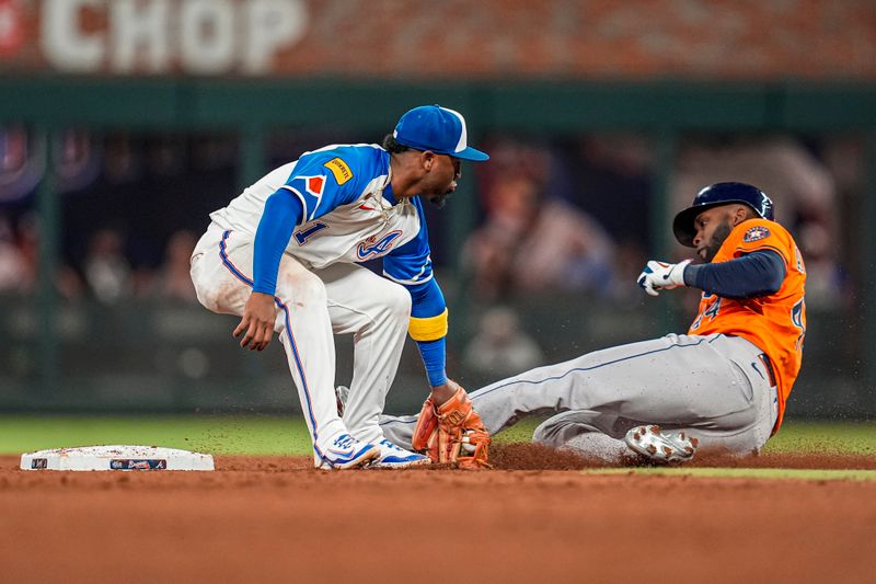 Sep 13, 2025; Cumberland, Georgia, USA; Atlanta Braves second baseman Ozzie Albies (1) tags out Houston Astros left fielder Yordan Alvarez (44) as he attempted to steal second base during the eighth inning at Truist Park. Mandatory Credit: Dale Zanine-Imagn Images