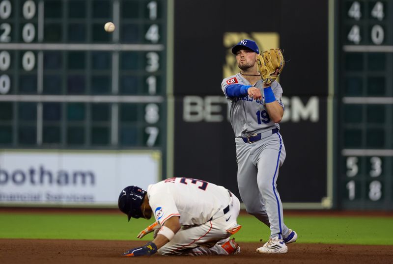 May 14, 2025; Houston, Texas, USA;  Kansas City Royals second baseman Michael Massey (19) turns a double play against Houston Astros shortstop Jeremy Pena (3) and Houston Astros left fielder Jose Altuve (not pictured) in the fourth inning at  Daikin Park. Mandatory Credit: Thomas Shea-Imagn Images
