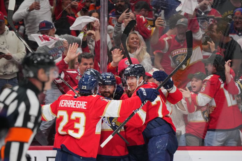Jun 24, 2024; Sunrise, Florida, USA; Florida Panthers forward Sam Reinhart (13) celebrates scoring during the second period against the Edmonton Oilers with forward Carter Verhaeghe (23) and defenseman Niko Mikkola (77) in game seven of the 2024 Stanley Cup Final at Amerant Bank Arena. Mandatory Credit: Jim Rassol-USA TODAY Sports