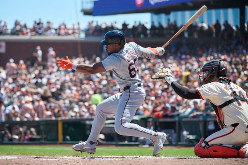 Aug 10, 2024; San Francisco, California, USA; Detroit Tigers outfielder Akil Baddoo (60) hits a single against San Francisco Giants catcher Patrick Bailey (14) during the fourth inning at Oracle Park. Mandatory Credit: Robert Edwards-USA TODAY Sports