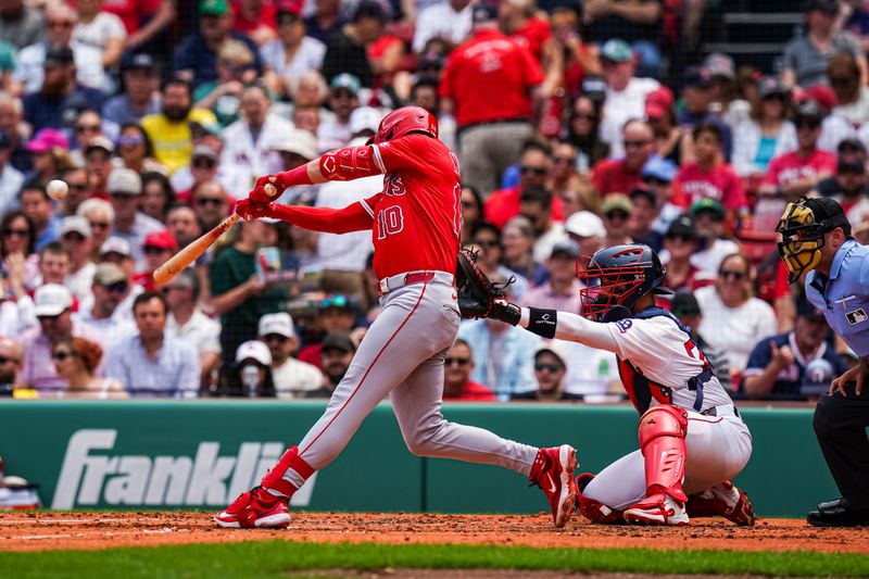 Jun 4, 2025; Boston, Massachusetts, USA; Los Angeles Angels third base Kevin Newman (10) hits a ground rule double against the Boston Red Sox in the second inning at Fenway Park. Mandatory Credit: David Butler II-Imagn Images