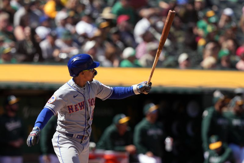 Apr 16, 2023; Oakland, California, USA; New York Mets shortstop Francisco Lindor (12) watches his home run against the Oakland Athletics during the sixth inning at RingCentral Coliseum. Mandatory Credit: Darren Yamashita-USA TODAY Sports