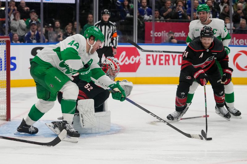 Mar 16, 2024; Toronto, Ontario, CAN; Toronto Maple Leafs defenseman Morgan Rielly (44) and Carolina Hurricanes defenseman Jaccob Slavin (74) reach for a rebound from goaltender Pyotr Kochetkov (52) during the third period at Scotiabank Arena. Mandatory Credit: John E. Sokolowski-USA TODAY Sports