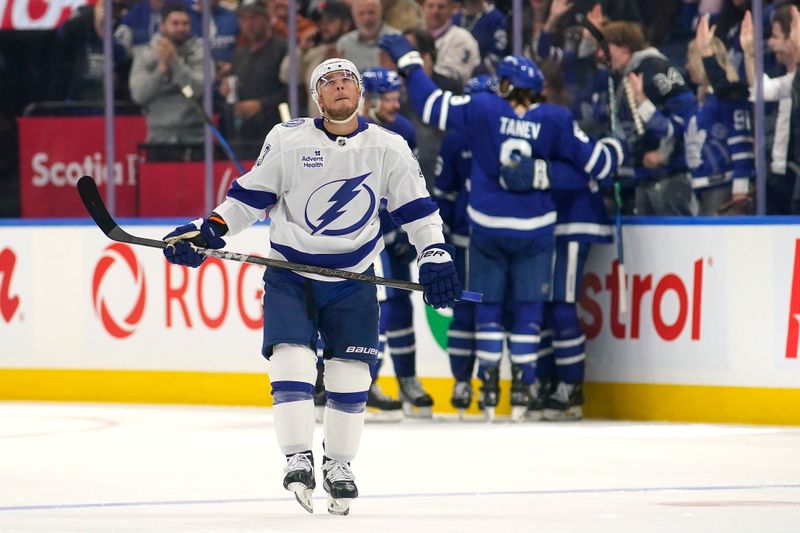 Oct 21, 2024; Toronto, Ontario, CAN; Tampa Bay Lightning forward Cameron Atkinson (13) skates to the bench as the Toronto Maple Leafs celebrate their fifth goal of the game  at Scotiabank Arena. Mandatory Credit: John E. Sokolowski-Imagn Images