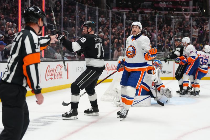 Mar 5, 2026; Los Angeles, California, USA; LA Kings center Samuel Helenius (79) celebrates after a goal as New York Islanders defenseman Carson Soucy (4) reacts in the second period at Crypto.com Arena. Mandatory Credit: Kirby Lee-Imagn Images