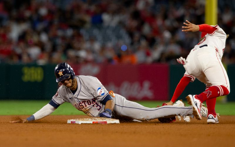 Sep 14, 2024; Anaheim, California, USA; Houston Astros shortstop Jeremy Pena (3) steals second in front of Los Angeles Angels shortstop Jack Lopez (10) the 5th inning at Angel Stadium. Mandatory Credit: Jason Parkhurst-Imagn Images