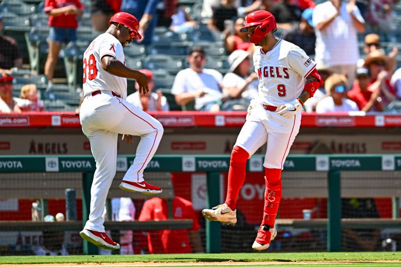 Aug 3, 2025; Anaheim, California, USA; Los Angeles Angels shortstop Zach Neto (9) celebrates with third base coach Bo Porter (88) after hitting a solo home run against the Chicago White Sox during the sixth inning at Angel Stadium. Mandatory Credit: Jonathan Hui-Imagn Images