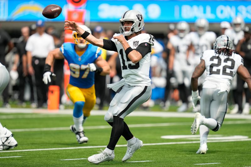 Las Vegas Raiders quarterback Gardner Minshew II (15) passes against the Los Angeles Chargers during the first half of an NFL football game, Sunday, Sept. 8, 2024, in Inglewood, Calif. (AP Photo/Ashley Landis)