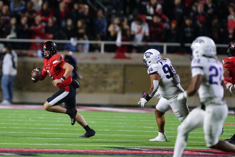 Nov 2, 2023; Lubbock, Texas, USA; Texas Tech Red Raiders quarterback Behren Morton (2) rushes against Texas Christian Horned Frogs defensive end Caleb Fox (90) in the second half at Jones AT&T Stadium and Cody Campbell Field. Mandatory Credit: Michael C. Johnson-USA TODAY Sports