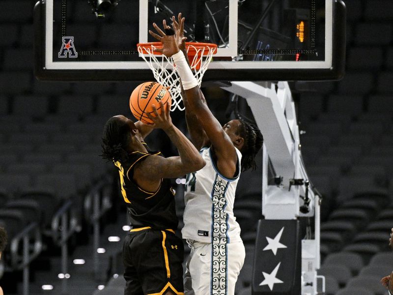 Mar 10, 2023; Fort Worth, TX, USA; Tulane Green Wave forward Kevin Cross (24) blocks a shot by Wichita State Shockers guard Jaron Pierre Jr. (5) during the second half at Dickies Arena. Mandatory Credit: Jerome Miron-USA TODAY Sports