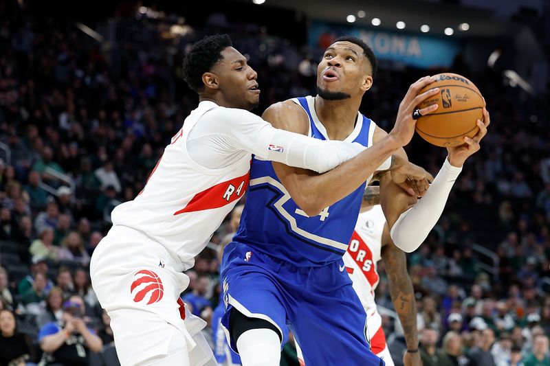 MILWAUKEE, WISCONSIN - JANUARY 17: Giannis Antetokounmpo #34 of the Milwaukee Bucks is fouled by RJ Barrett #9 of the Toronto Raptors going up for a shot during the second half of the game at Fiserv Forum on January 17, 2025 in Milwaukee, Wisconsin. NOTE TO USER: User expressly acknowledges and agrees that, by downloading and or using this photograph, User is consenting to the terms and conditions of the Getty Images License Agreement. (Photo by John Fisher/Getty Images)