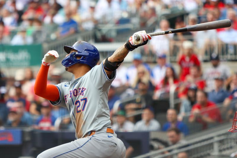 Sep 30, 2024; Atlanta, Georgia, USA; New York Mets third baseman Mark Vientos (27) drives in a run on a sacrifice fly against the Atlanta Braves in the eighth inning at Truist Park. Mandatory Credit: Brett Davis-Imagn Images
