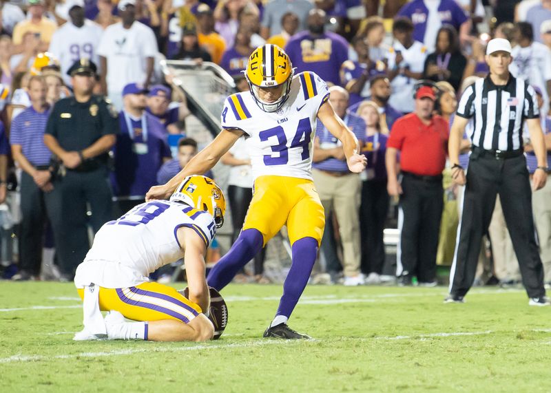 Sep 23, 2023; Baton Rouge, Louisiana, USA; LSU Tigers place kicker Damian Ramos (34) kicks the game winning field goal against the Arkansas Razorbacks  during the game at Tiger Stadium. Mandatory Credit: Scott Clause-USA TODAY Sports