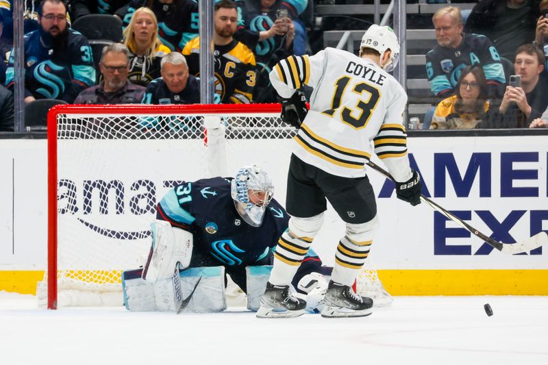 Feb 26, 2024; Seattle, Washington, USA; Seattle Kraken goaltender Philipp Grubauer (31) makes a save against Boston Bruins center Charlie Coyle (13) during an overtime shootout at Climate Pledge Arena. Mandatory Credit: Joe Nicholson-USA TODAY Sports