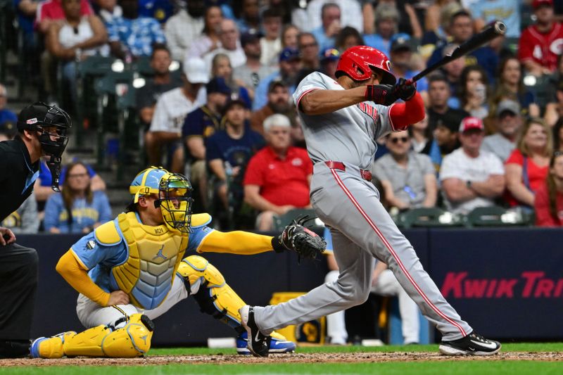 Jun 14, 2024; Milwaukee, Wisconsin, USA; Cincinnati Reds third baseman Jeimer Candelario (3) hits a two-run home run as Milwaukee Brewers catcher William Contreras (24) looks on in the fifth inning at American Family Field. Mandatory Credit: Benny Sieu-USA TODAY Sports