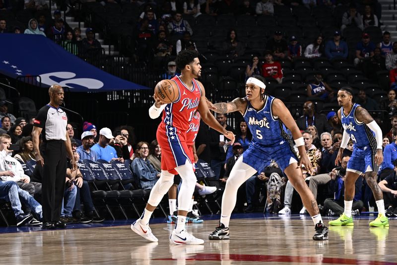 PHILADELPHIA, PA - APRIL 12:Paolo Banchero #5 of the Orlando Magic plays defense against Tobias Harris #12 of the Philadelphia 76ers during the game  on April 12, 2024 at the Wells Fargo Center in Philadelphia, Pennsylvania NOTE TO USER: User expressly acknowledges and agrees that, by downloading and/or using this Photograph, user is consenting to the terms and conditions of the Getty Images License Agreement. Mandatory Copyright Notice: Copyright 2024 NBAE (Photo by David Dow/NBAE via Getty Images)