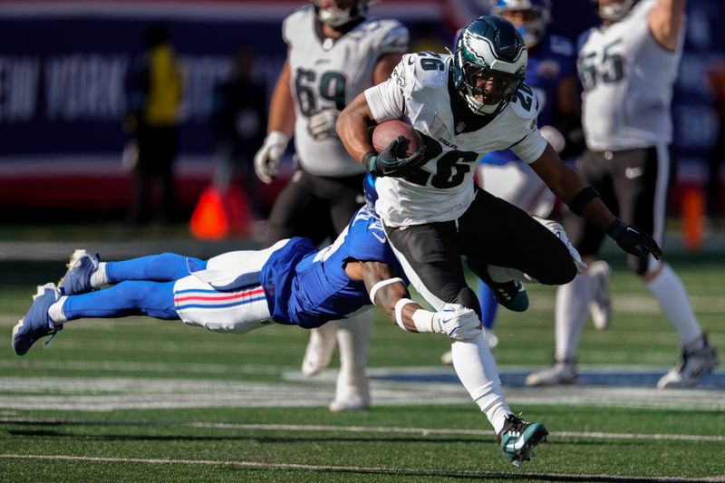 Philadelphia Eagles running back Saquon Barkley (26) avoids a tackle from New York Giants safety Jason Pinnock (27) during the third quarter of an NFL football game, Sunday, Oct. 20, 2024, in East Rutherford, N.J. (AP Photo/Seth Wenig)