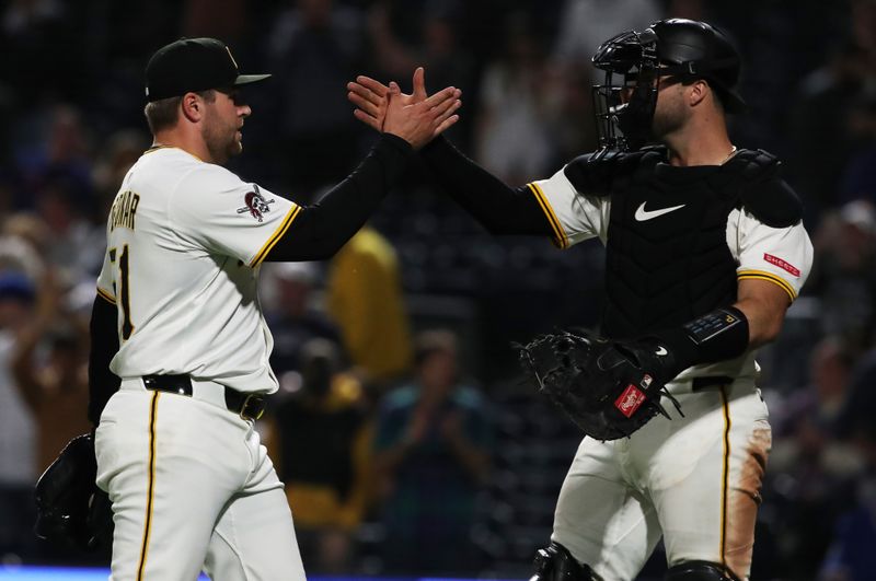 Apr 30, 2025; Pittsburgh, Pennsylvania, USA;  Pittsburgh Pirates relief pitcher David Bednar (51) and catcher Joey Bart (14) celebrate after defeating the Chicago Cubs at PNC Park. Mandatory Credit: Charles LeClaire-Imagn Images