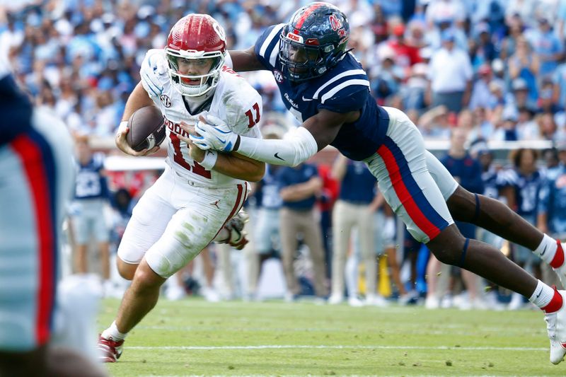 Oct 26, 2024; Oxford, Mississippi, USA; Mississippi Rebels linebacker Suntarine Perkins (4) sacks Oklahoma Sooners quarterback Jackson Arnold (11) during the first half at Vaught-Hemingway Stadium. Mandatory Credit: Petre Thomas-Imagn Images