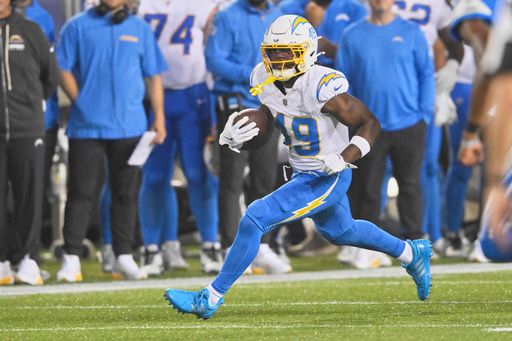 Los Angeles Chargers cornerback Myles Purchase (49) runs with the ball after an interception in the second half of the Pro Football Hall of Fame NFL preseason game against the Detroit Lions, Thursday, July 31, 2025, in Canton, Ohio. (AP Photo/David Richard)