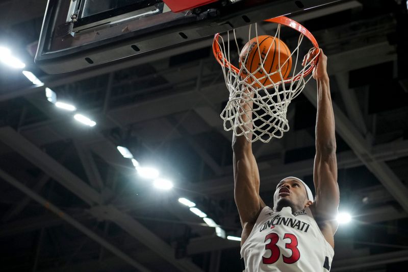 Nov 10, 2023; Cincinnati, Ohio, USA;  Cincinnati Bearcats forward Ody Oguama (33) dunks the ball against the Detroit Mercy Titans in the second half at Fifth Third Arena. Mandatory Credit: Aaron Doster-USA TODAY Sports