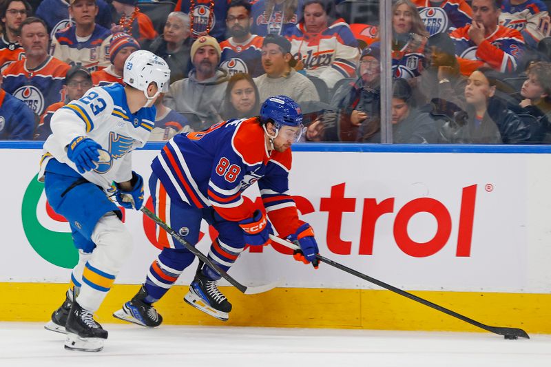 Jan 18, 2026; Edmonton, Alberta, CAN; Edmonton Oilers forward Andrew Mangiapane (88) protects the puck from St. Louis Blues defensemen Logan Mailloux (23) during the first period at Rogers Place. Mandatory Credit: Perry Nelson-Imagn Images