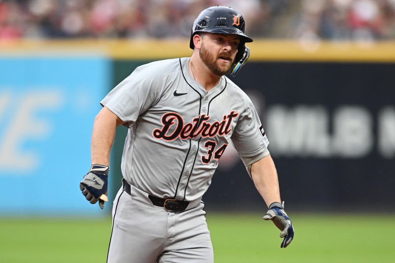 Jul 22, 2024; Cleveland, Ohio, USA; Detroit Tigers catcher Jake Rogers (34) rounds the bases en route to a triple during the second inning against the Cleveland Guardians at Progressive Field. Rogers ended up with a triple and scoring on a throwing error by Martinez. Mandatory Credit: Ken Blaze-USA TODAY Sports