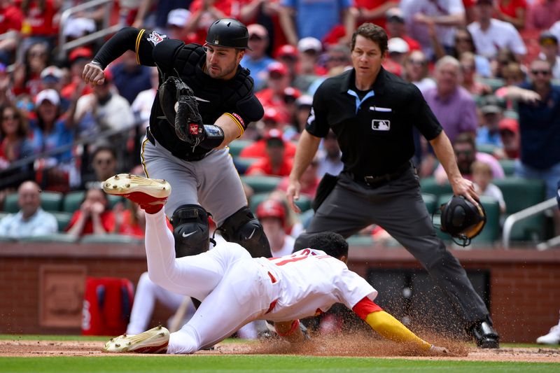 May 7, 2025; St. Louis, Missouri, USA;  St. Louis Cardinals center fielder Victor Scott II (11) slides safely past Pittsburgh Pirates catcher Joey Bart (14) to score during the third inning at Busch Stadium. Mandatory Credit: Jeff Curry-Imagn Images