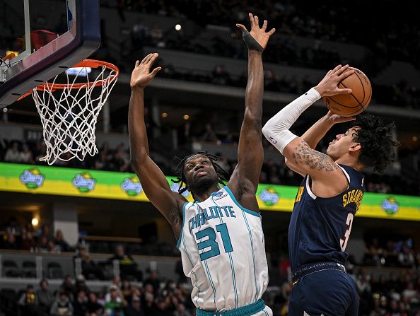 DENVER, CO - JANUARY 1: Julian Strawther (3) of the Denver Nuggets shots over Nathan Mensah (31) of the Charlotte Hornets during the fourth quarter of the Nuggets' 111-93 win at Ball Arena in Denver on Monday, January 1, 2024. (Photo by AAron Ontiveroz/The Denver Post)