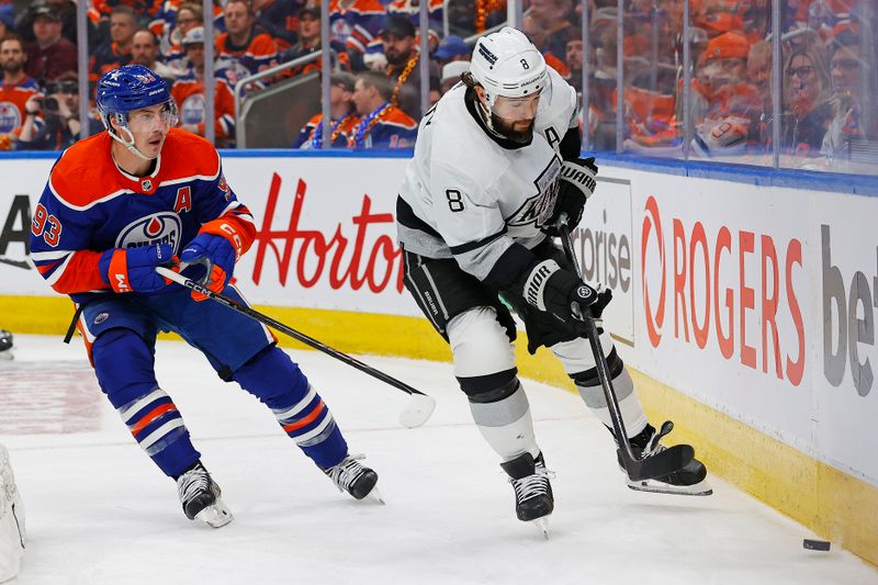 Apr 22, 2024; Edmonton, Alberta, CAN; Edmonton Oilers forward Ryan Nugent-Hopkins (93) and Los Angeles Kings defensemen Drew Doughty (8) battle for a loose puck  during the third period in game one of the first round of the 2024 Stanley Cup Playoffs at Rogers Place. Mandatory Credit: Perry Nelson-USA TODAY Sports