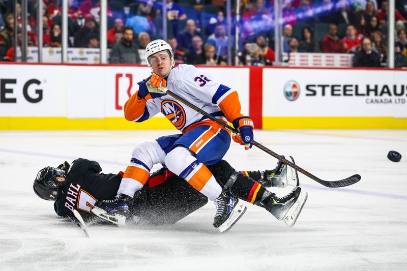 Nov 19, 2024; Calgary, Alberta, CAN; New York Islanders center Kyle MacLean (32) and Calgary Flames defenseman Kevin Bahl (7) battles for the puck during the third period at Scotiabank Saddledome. Mandatory Credit: Sergei Belski-Imagn Images