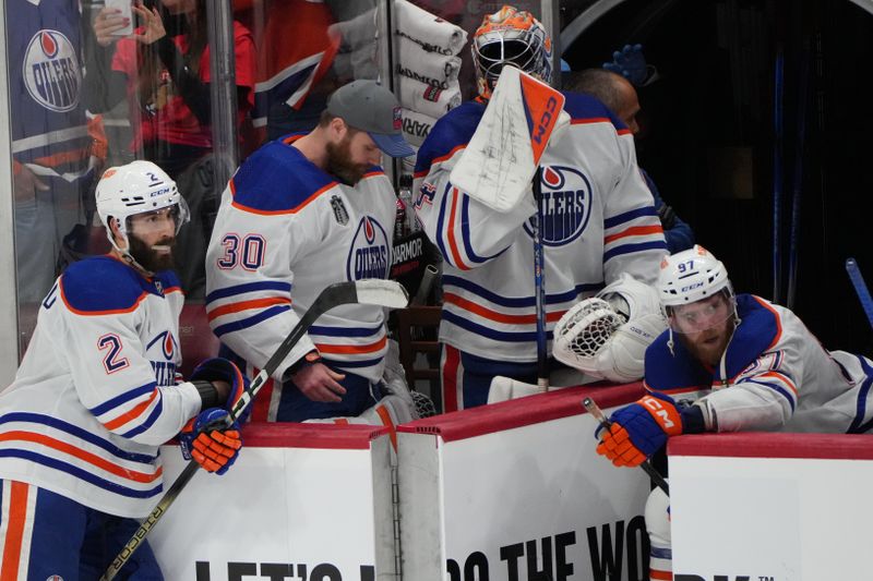 Jun 24, 2024; Sunrise, Florida, USA; Edmonton Oilers forward Connor McDavid (97) and goaltender Calvin Pickard (30) and defenseman Evan Bouchard (2) react to the loss against the Florida Panthers in game seven of the 2024 Stanley Cup Final at Amerant Bank Arena. Mandatory Credit: Jim Rassol-USA TODAY Sports