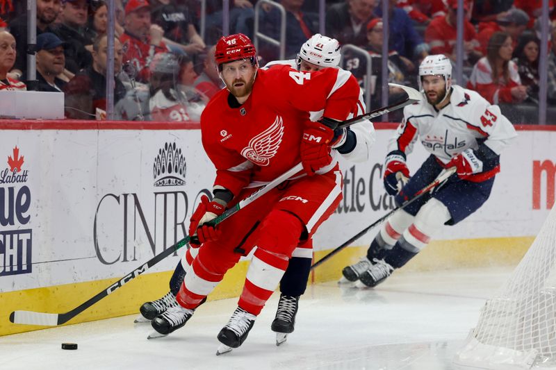 Apr 9, 2024; Detroit, Michigan, USA; Detroit Red Wings defenseman Jeff Petry (46) skates with the puck chased by Washington Capitals center Aliaksei Protas (21) in the first period at Little Caesars Arena. Mandatory Credit: Rick Osentoski-USA TODAY Sports