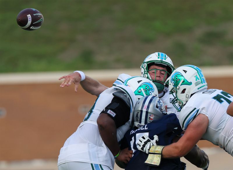 Oct 28, 2023; Houston, Texas, USA; Tulane Green Wave quarterback Michael Pratt (7) gets rid of the ball before being hit by the Rice Owls in the second half at Rice Stadium. Mandatory Credit: Thomas Shea-USA TODAY Sports