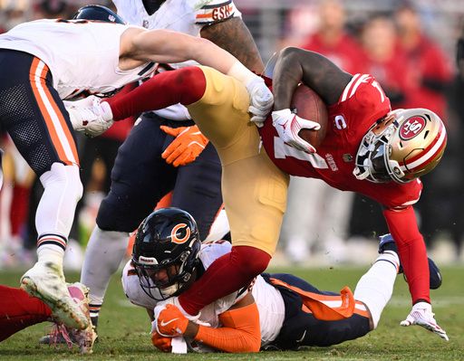 San Francisco 49ers wide receiver Deebo Samuel Sr. (1) gets tripped up by Chicago Bears safety Kevin Byard III (31) in the second half an NFL football game in Santa Clara, Calif., Sunday, Dec. 8, 2024. (AP Photo/Eakin Howard)